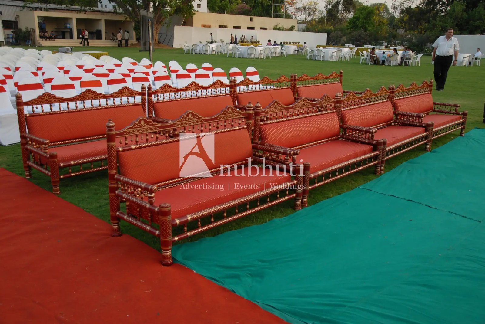 Group of men posing with large cartoon character inflatable figures at night outdoors
